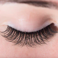 a close up of a woman's eye with long lashes