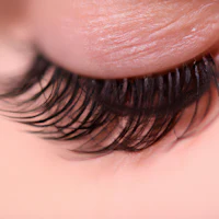a close up of a woman's eye with long lashes